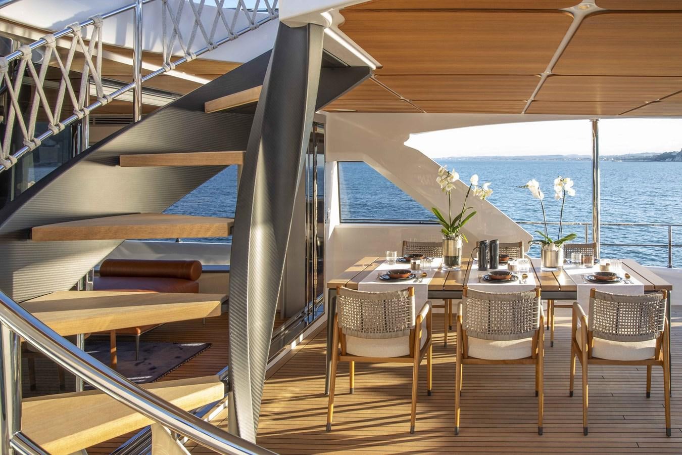 a room with a table and chairs aboard CUSTOM LINE NAVETTA 33/33 Yacht for Sale