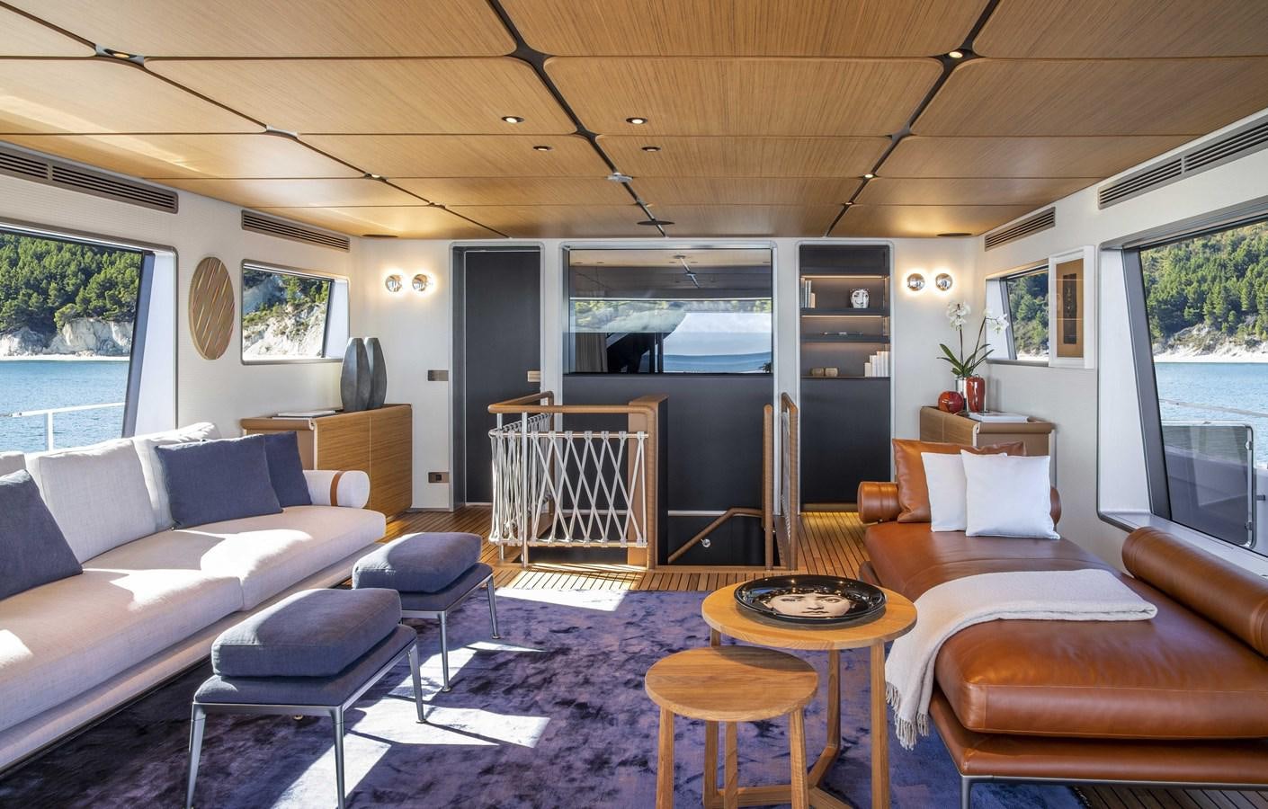 a living room with a blue rug aboard CUSTOM LINE NAVETTA 33/33 Yacht for Sale