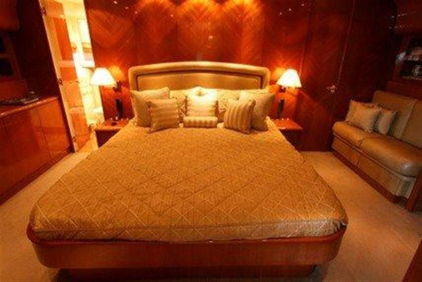 a bed with a couch and a lamp in a room aboard SKS Yacht for Sale