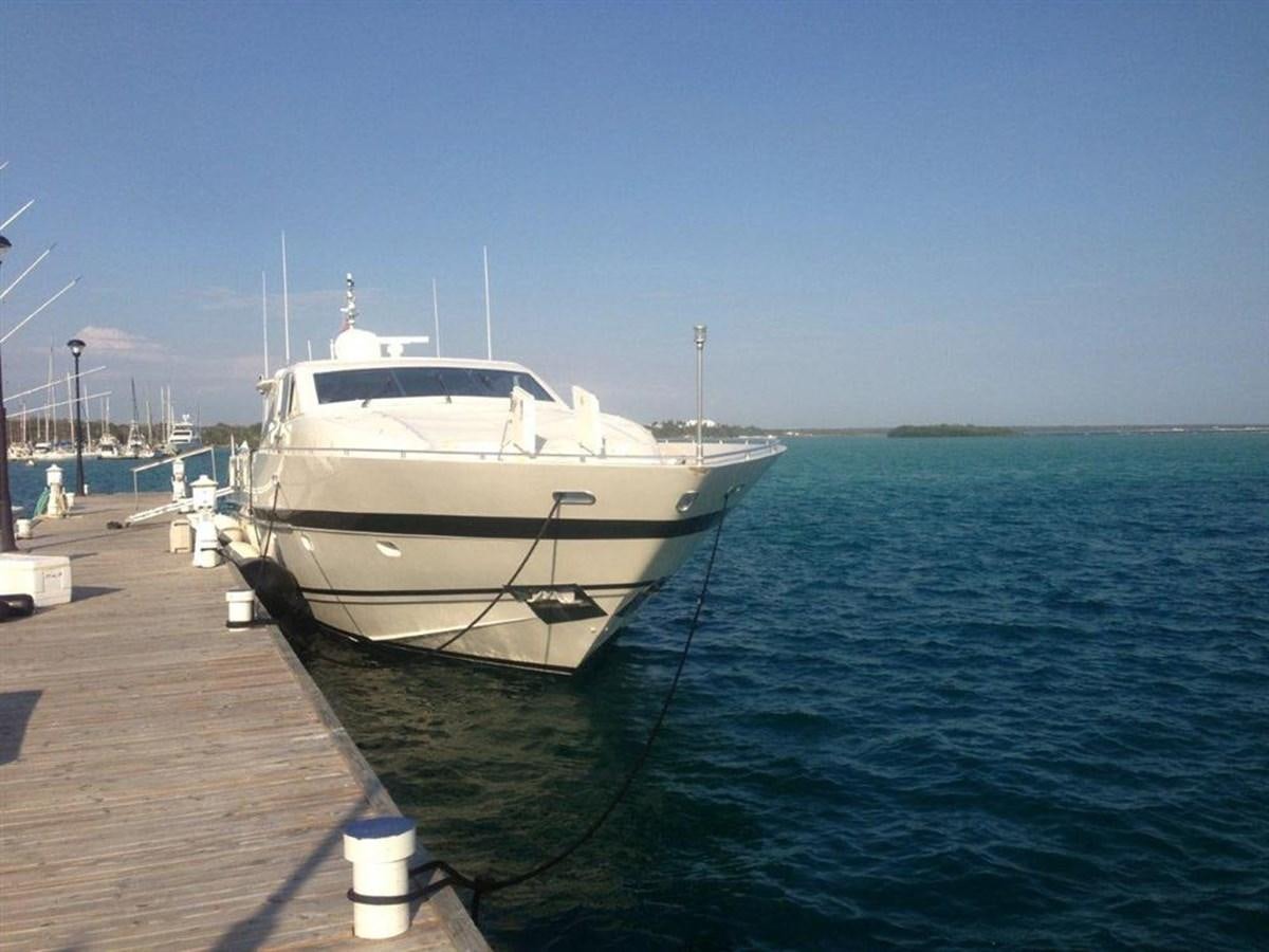 a white boat tied to a dock aboard SKS Yacht for Sale