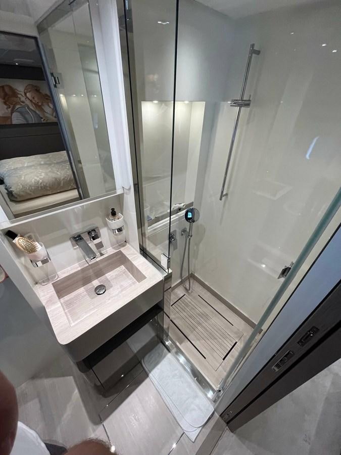 a bathroom with a glass shower aboard 2021 SANLORENZO SL78 #721 Yacht for Sale