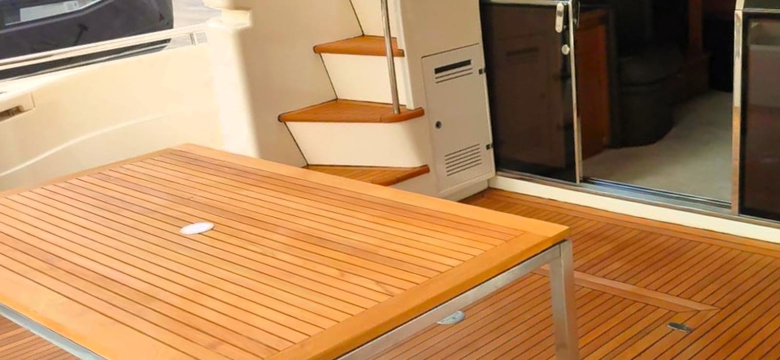 a wooden table with a wood frame aboard GOLDEN EX Yacht for Sale