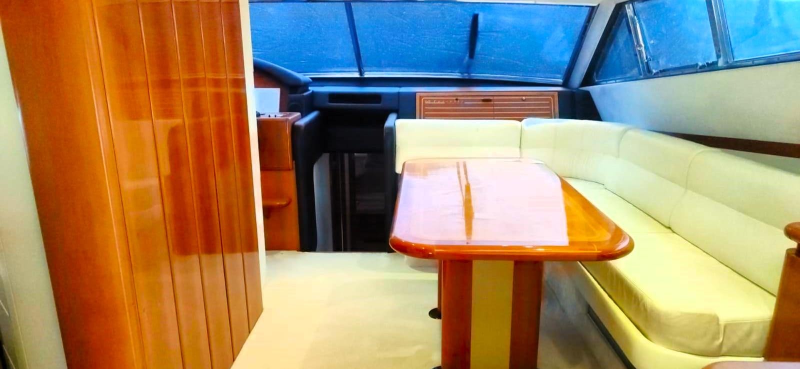 a room with a table and chairs aboard GOLDEN EX Yacht for Sale