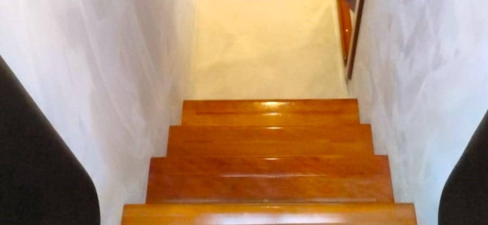 a wooden shelf with a white curtain aboard GOLDEN EX Yacht for Sale
