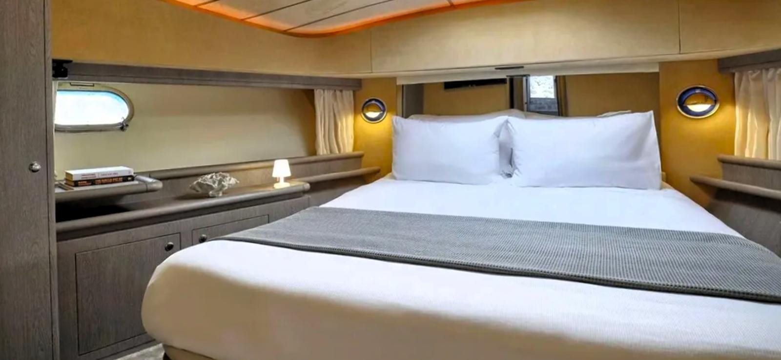 a bed with white sheets aboard GOLDEN EX Yacht for Sale