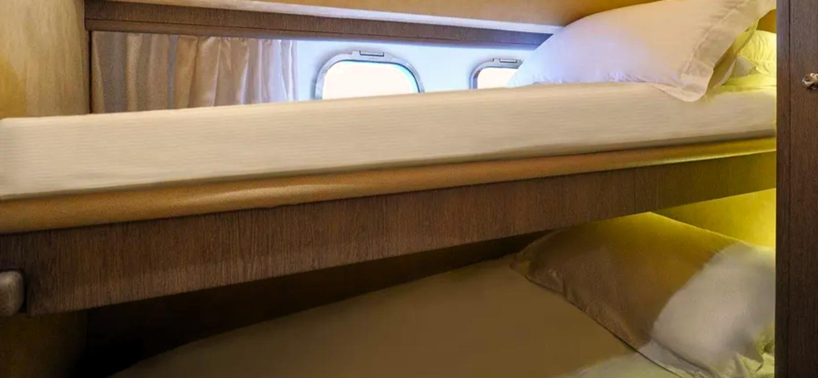 a bed with a white sheet aboard GOLDEN EX Yacht for Sale