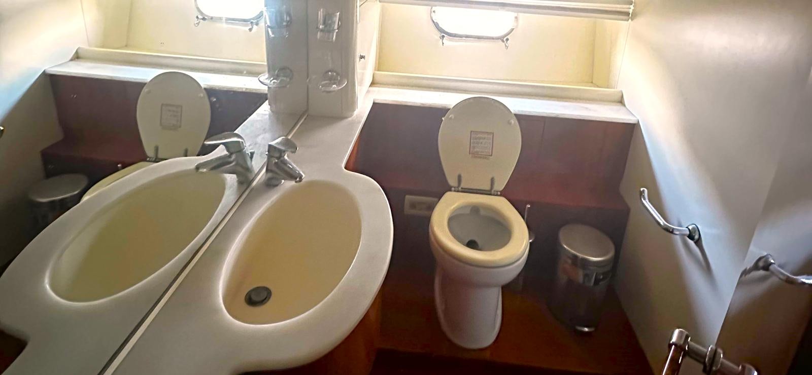a toilet with a sink and a toilet aboard GOLDEN EX Yacht for Sale