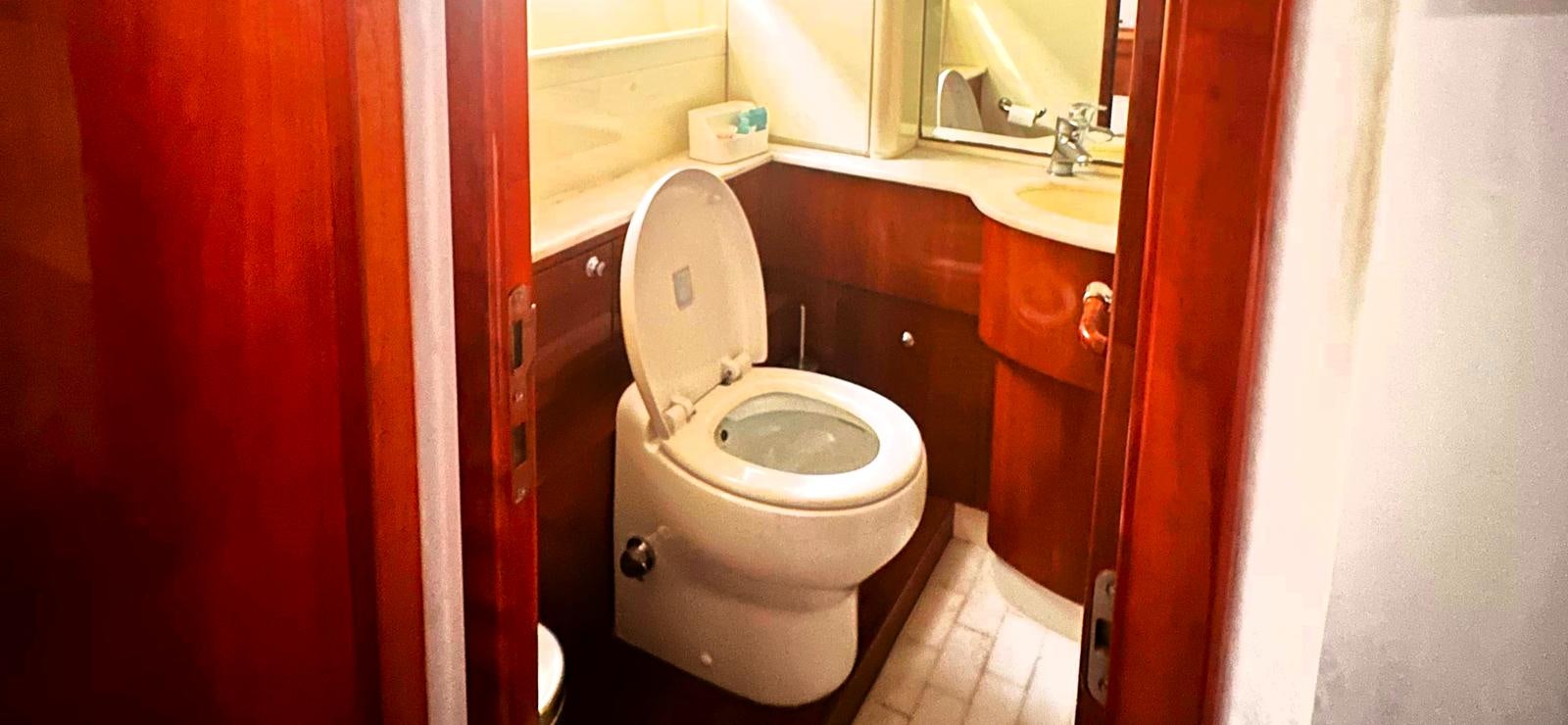a toilet in a bathroom aboard GOLDEN EX Yacht for Sale