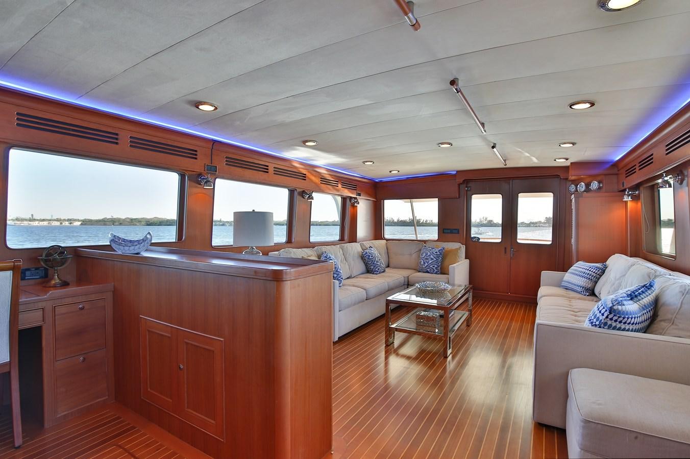 a living room with a couch and a table aboard BESPOKE Yacht for Sale