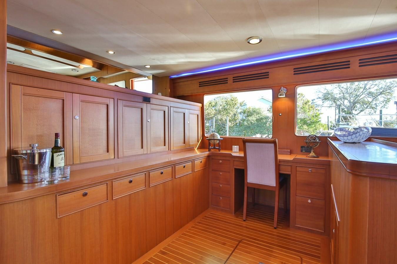 a kitchen with wooden cabinets aboard BESPOKE Yacht for Sale