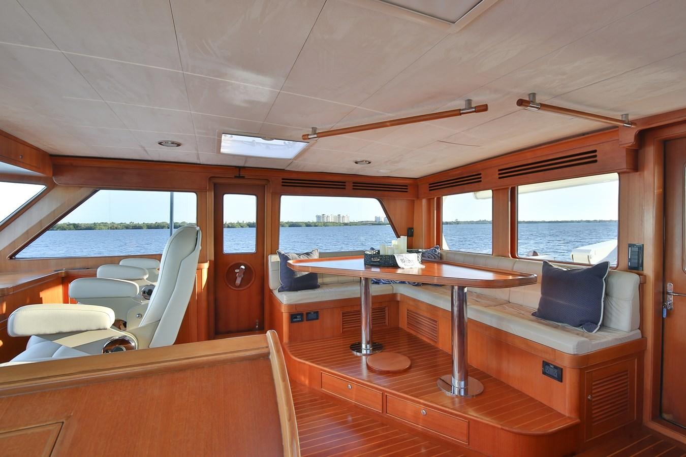 a boat with a table and chairs aboard BESPOKE Yacht for Sale