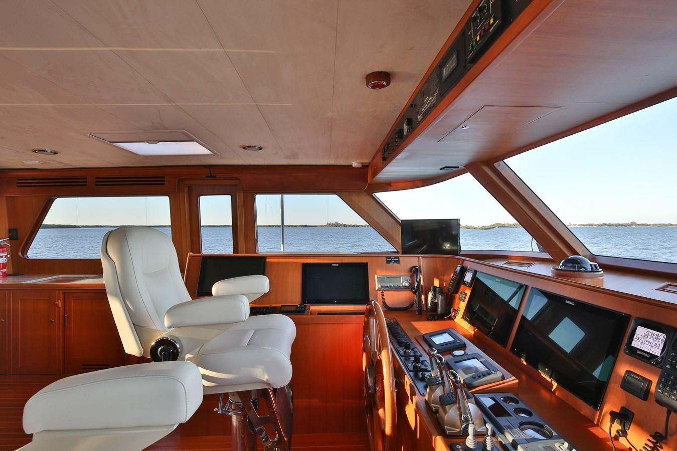 a room with a desk and chairs aboard BESPOKE Yacht for Sale