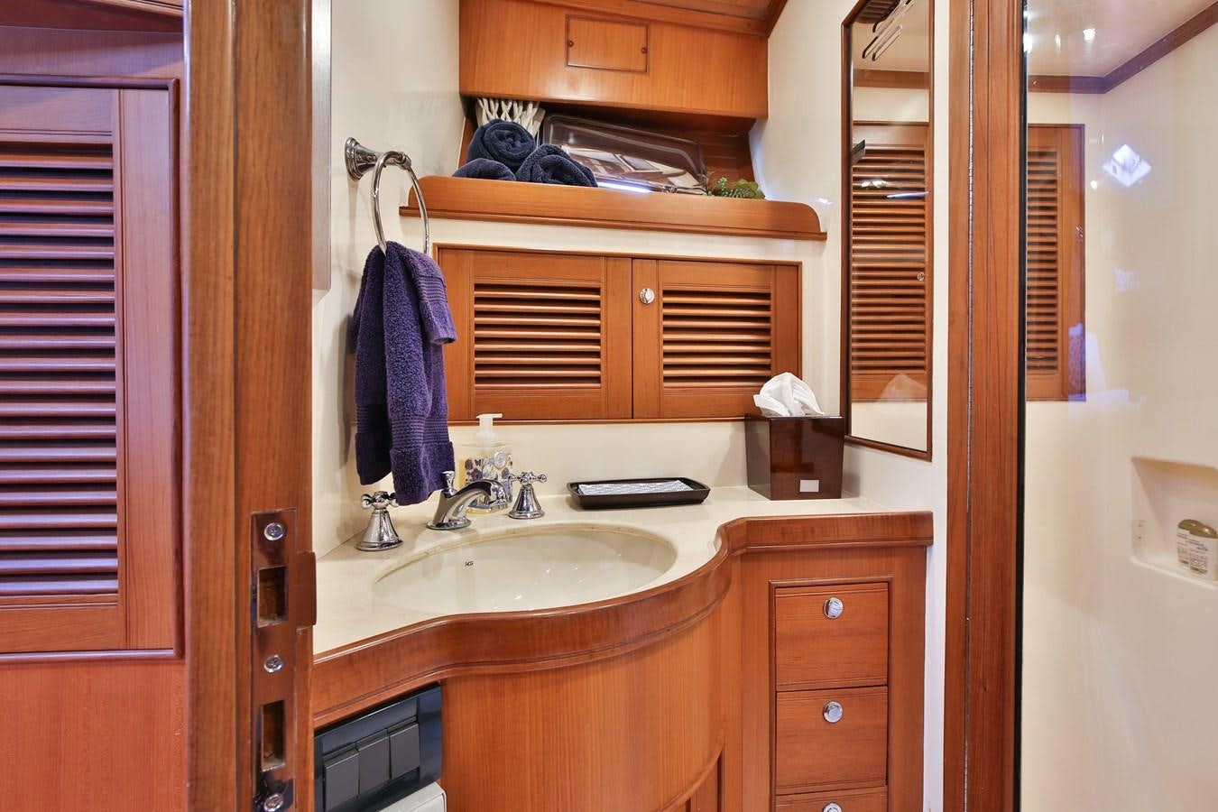 a bathroom with a sink and cabinets aboard BESPOKE Yacht for Sale