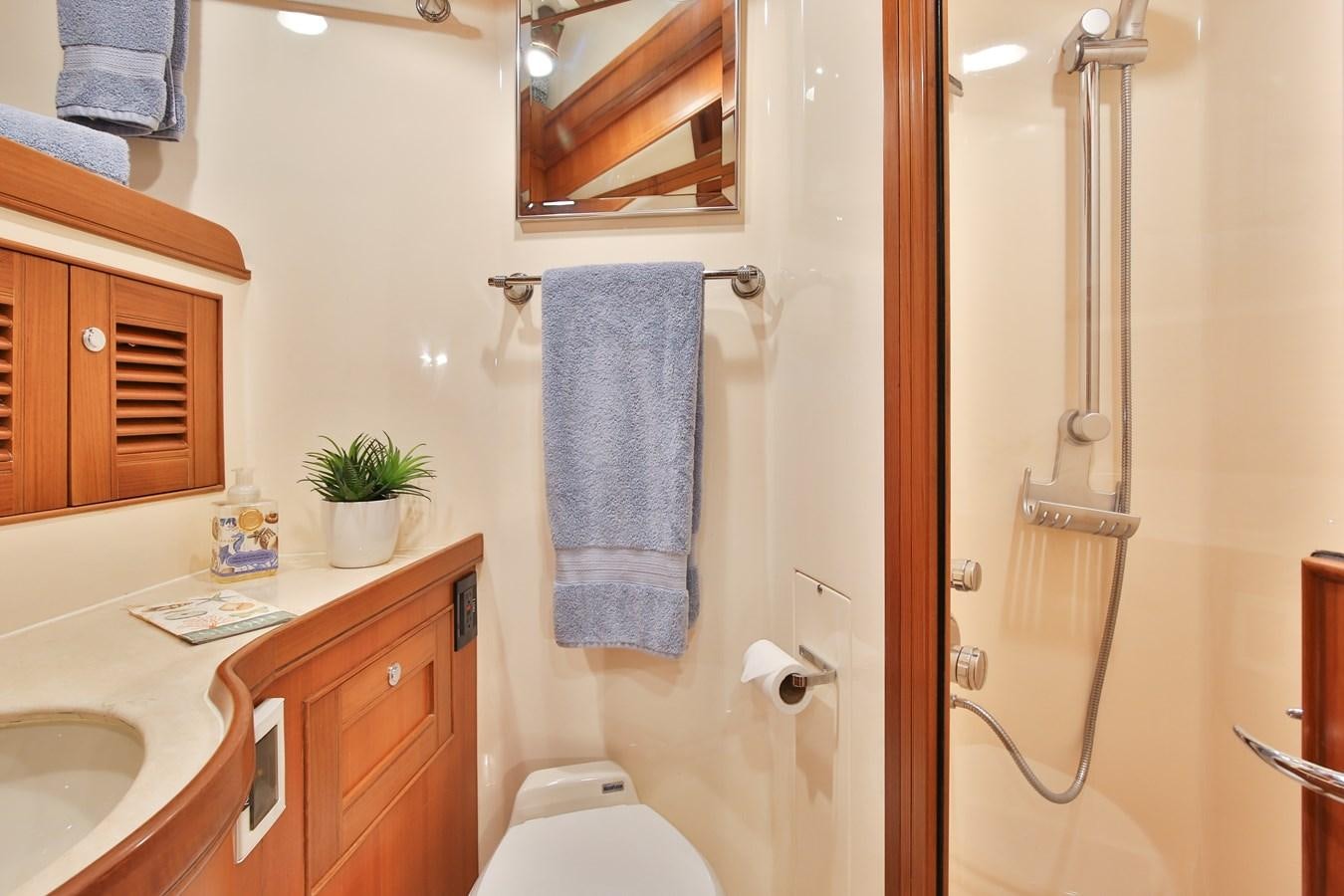 a bathroom with a shower and sink aboard BESPOKE Yacht for Sale