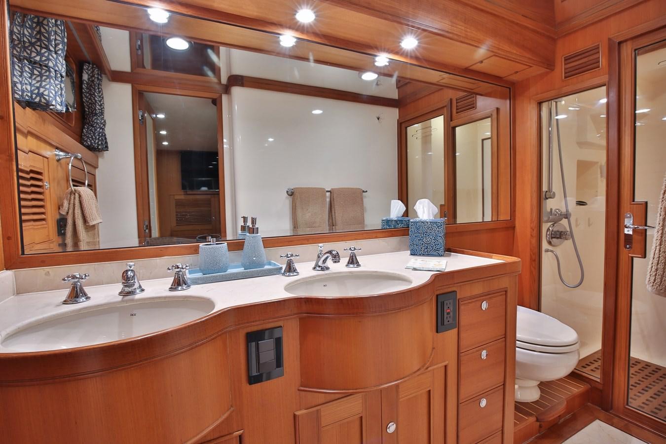 a bathroom with a large mirror aboard BESPOKE Yacht for Sale