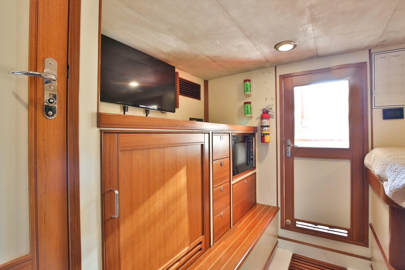 a kitchen with wooden cabinets aboard BESPOKE Yacht for Sale