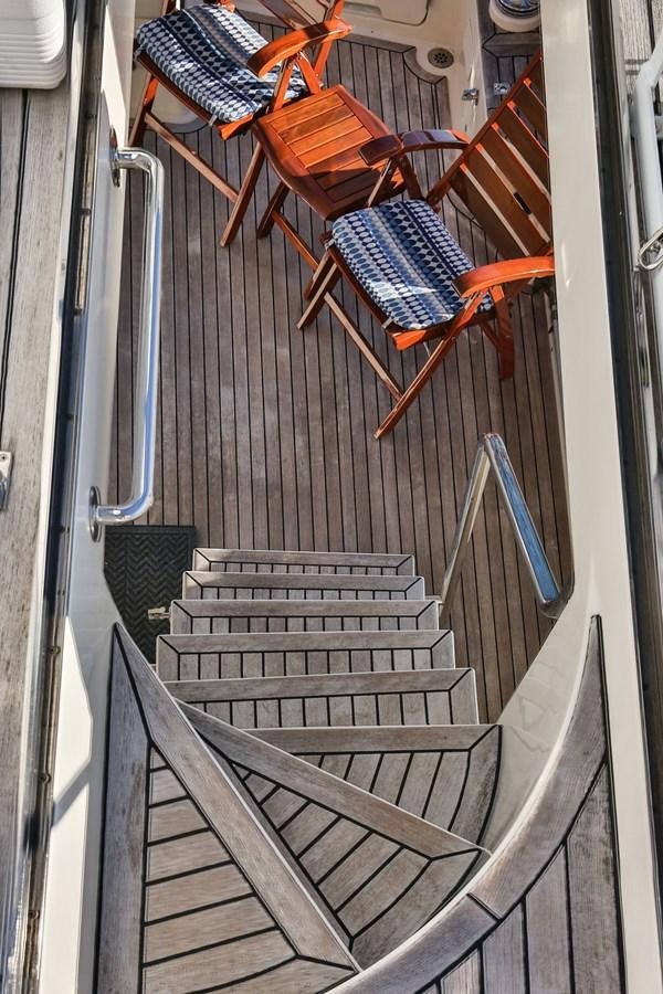 a set of wooden stairs aboard BESPOKE Yacht for Sale