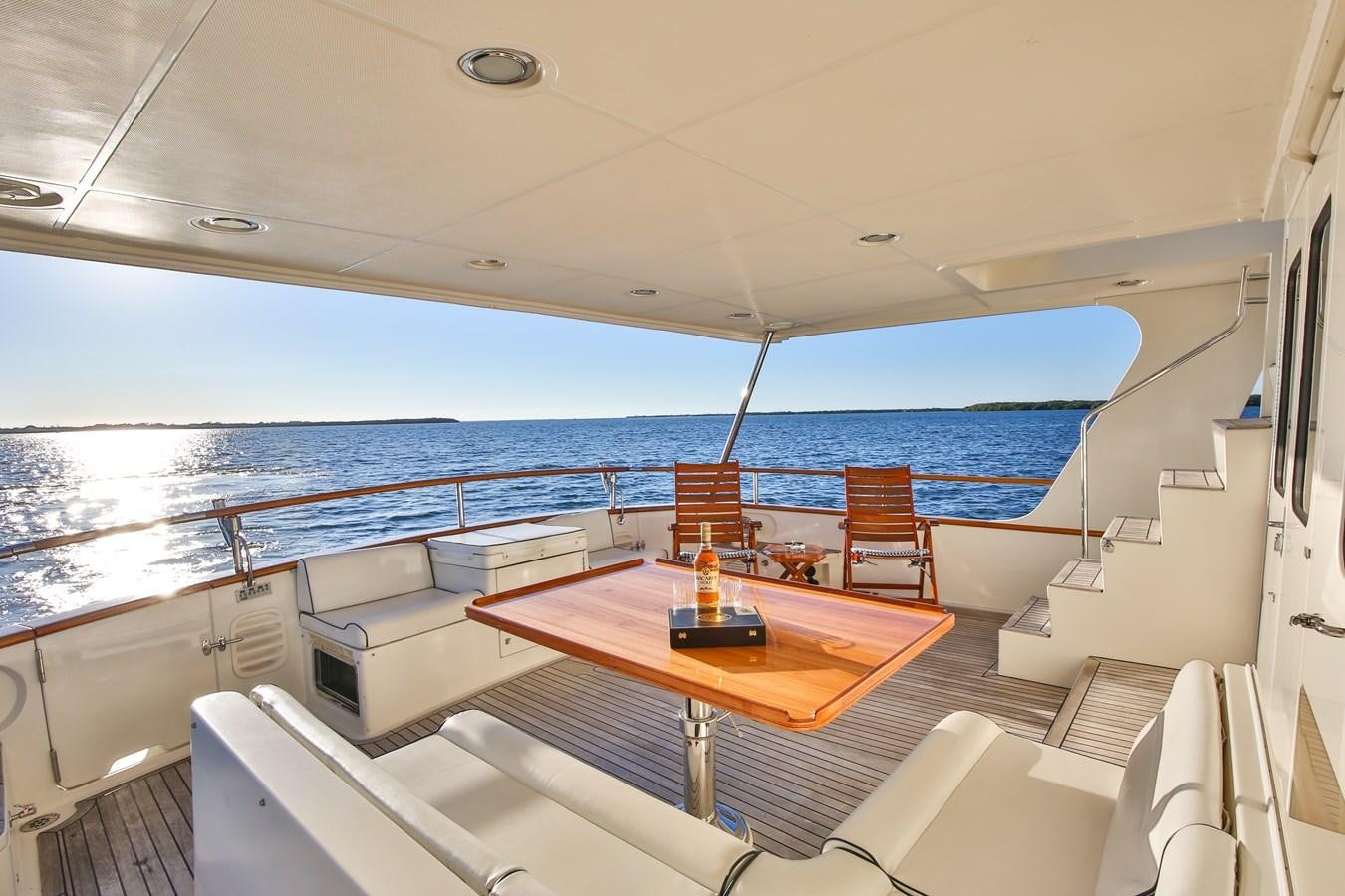 a boat with a table and chairs aboard BESPOKE Yacht for Sale
