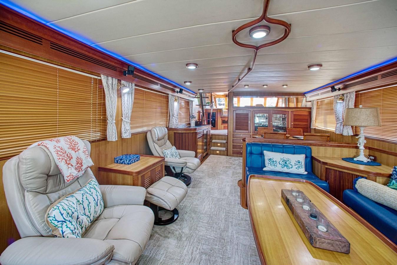 a living room with a couch and a table aboard DISCONNECTED Yacht for Sale