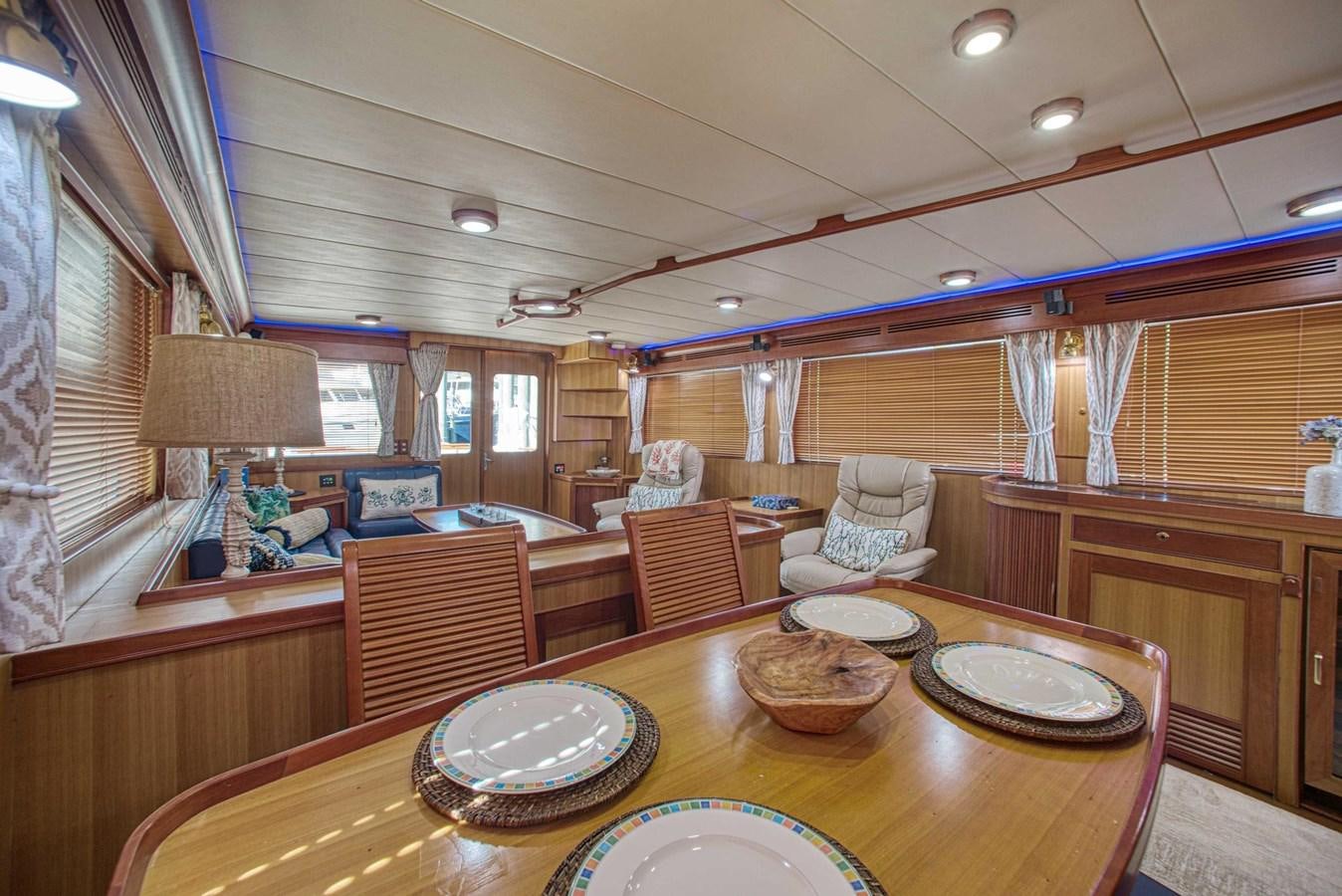 a large room with a table and chairs aboard DISCONNECTED Yacht for Sale