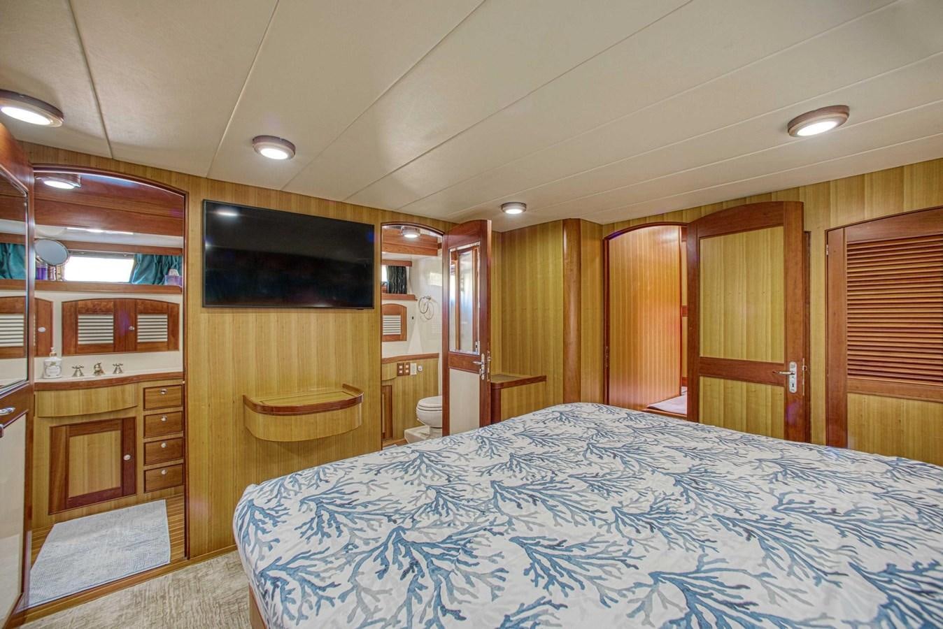a bedroom with a bed and a closet aboard DISCONNECTED Yacht for Sale