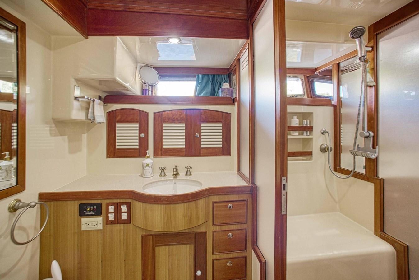 a bathroom with a sink and a mirror aboard DISCONNECTED Yacht for Sale