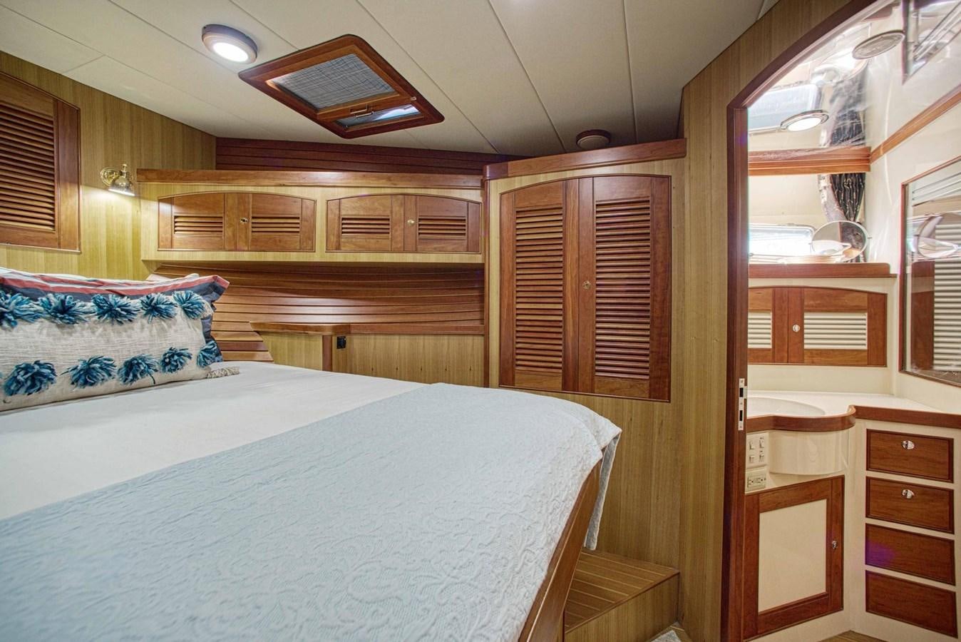 a bedroom with a bed and a closet aboard DISCONNECTED Yacht for Sale