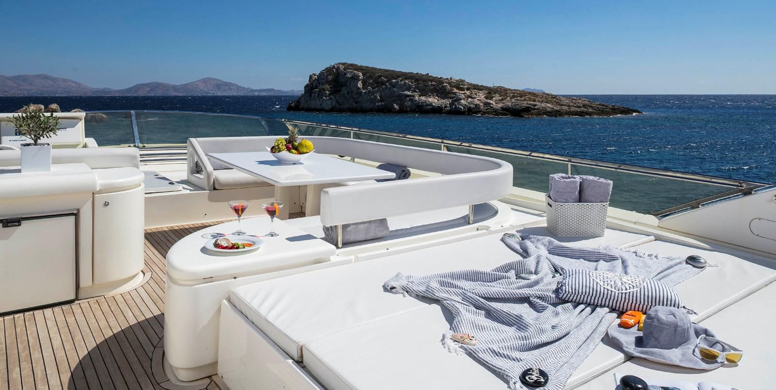 a white lounge chair on a deck overlooking a large body of water aboard LAZY DAYS Yacht for Sale