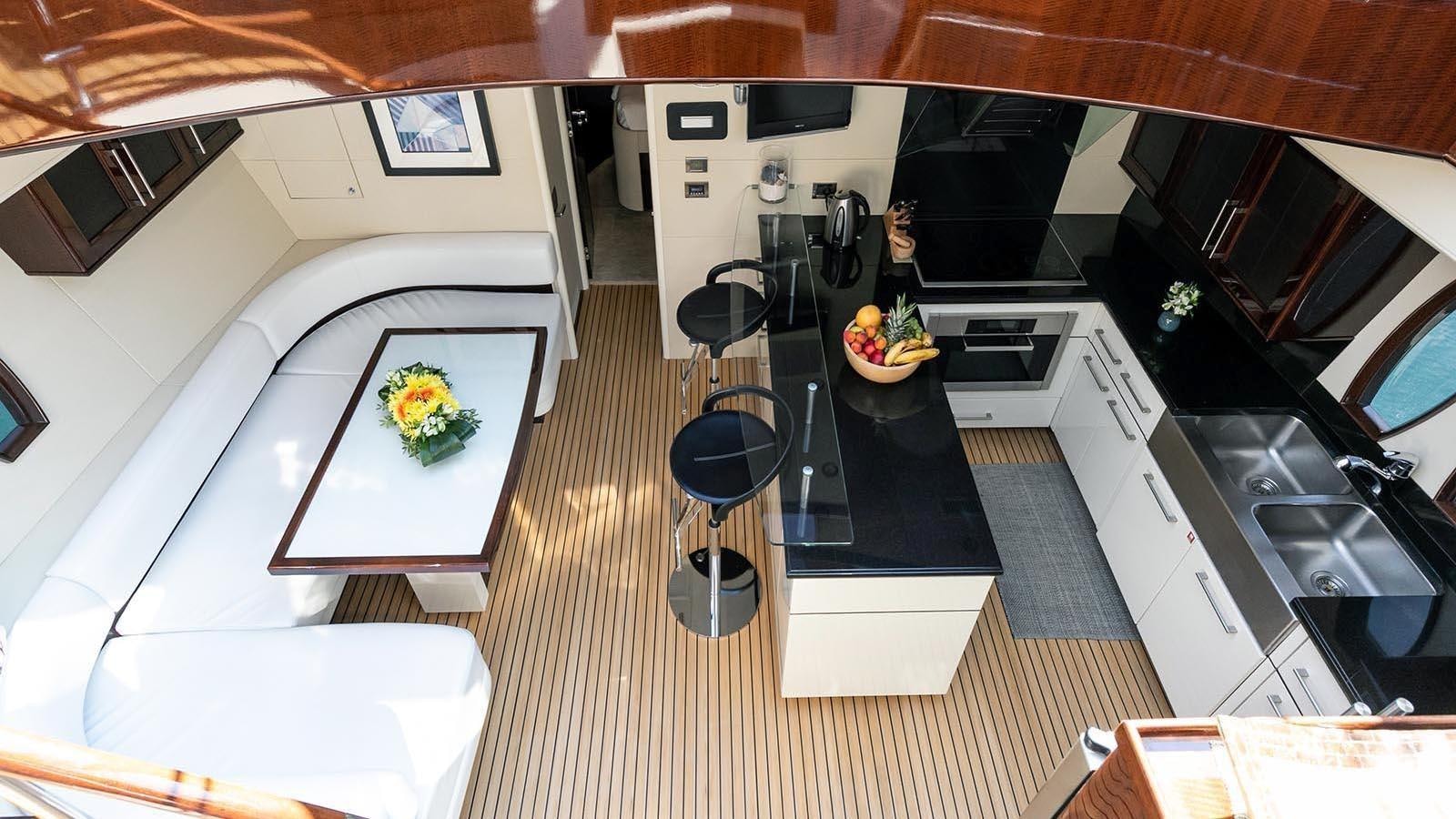 a kitchen with a table and chairs aboard 2008 LAZZARA LSX 75 Yacht for Sale