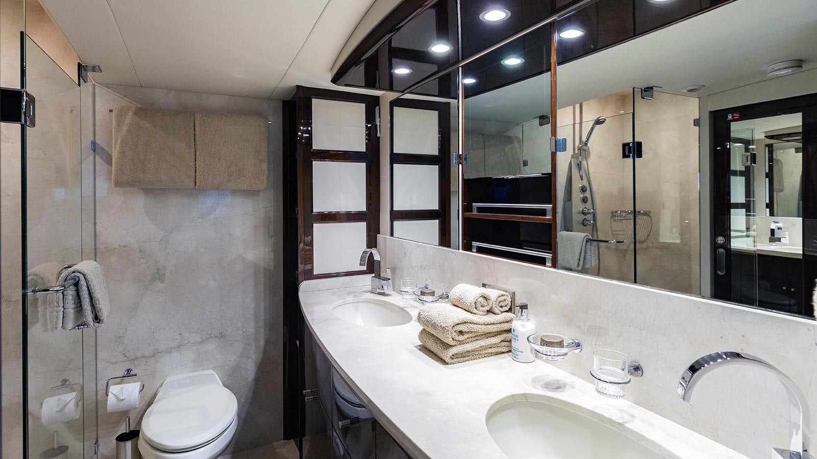 a bathroom with a large mirror aboard 2008 LAZZARA LSX 75 Yacht for Sale