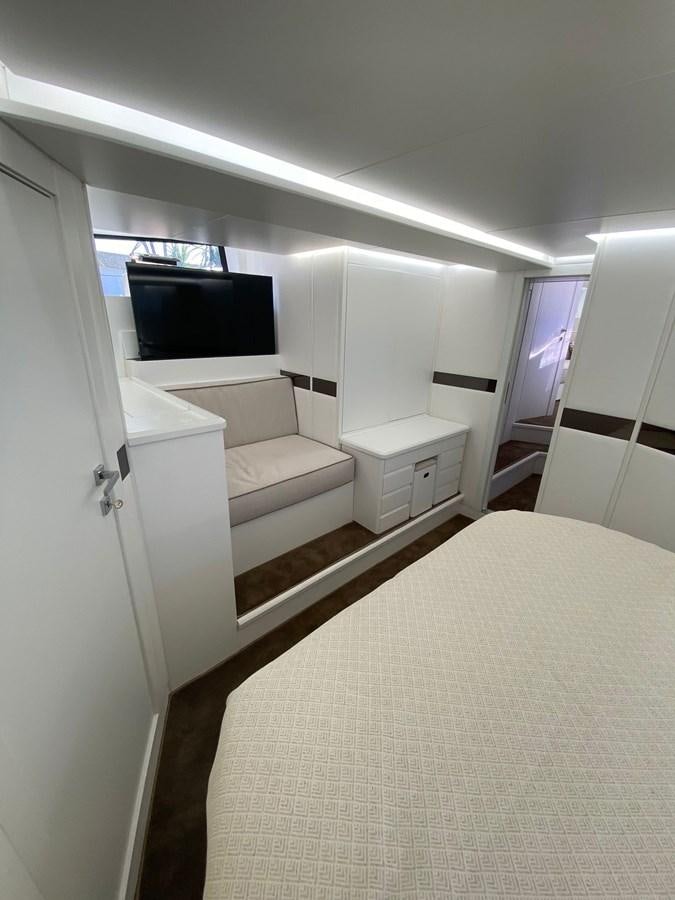 a room with a bed and a television aboard SUERT 70 Yacht for Sale