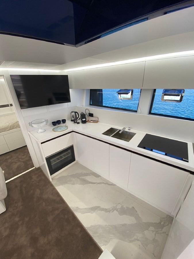 a kitchen with white cabinets aboard SUERT 70 Yacht for Sale