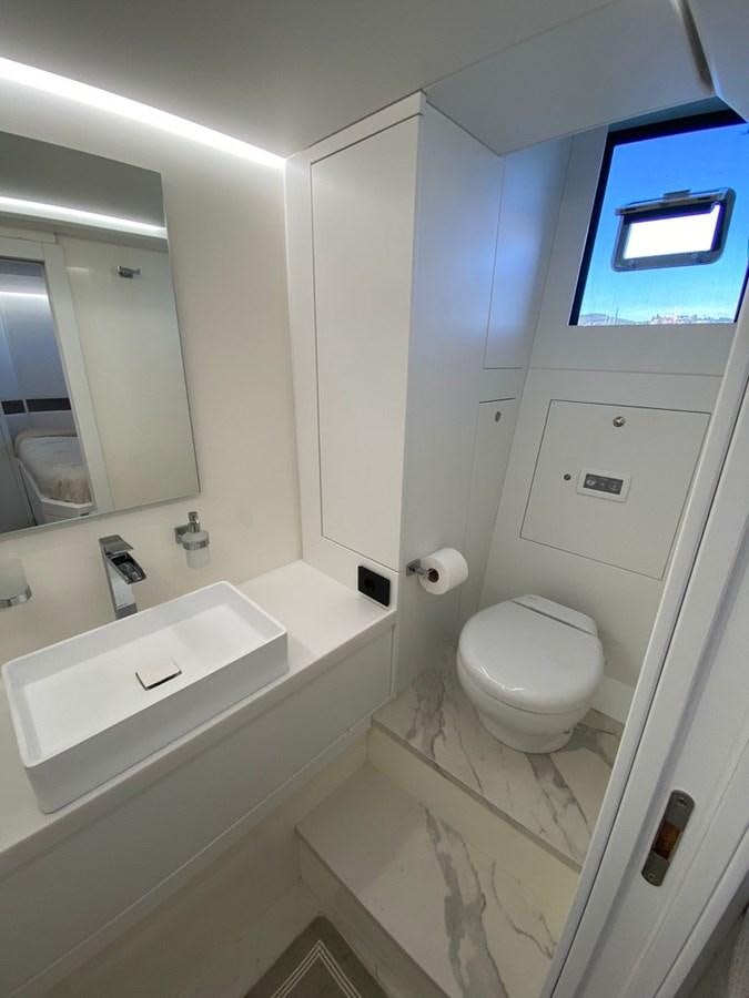a bathroom with a toilet and a bathtub aboard SUERT 70 Yacht for Sale
