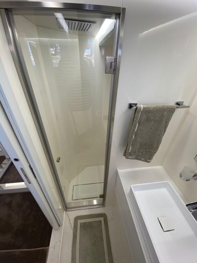 a bathroom with a glass shower aboard SUERT 70 Yacht for Sale