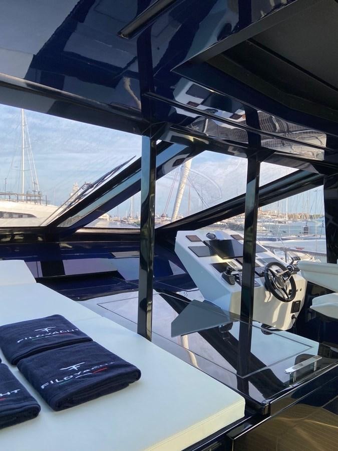 a black phone on a table aboard SUERT 70 Yacht for Sale