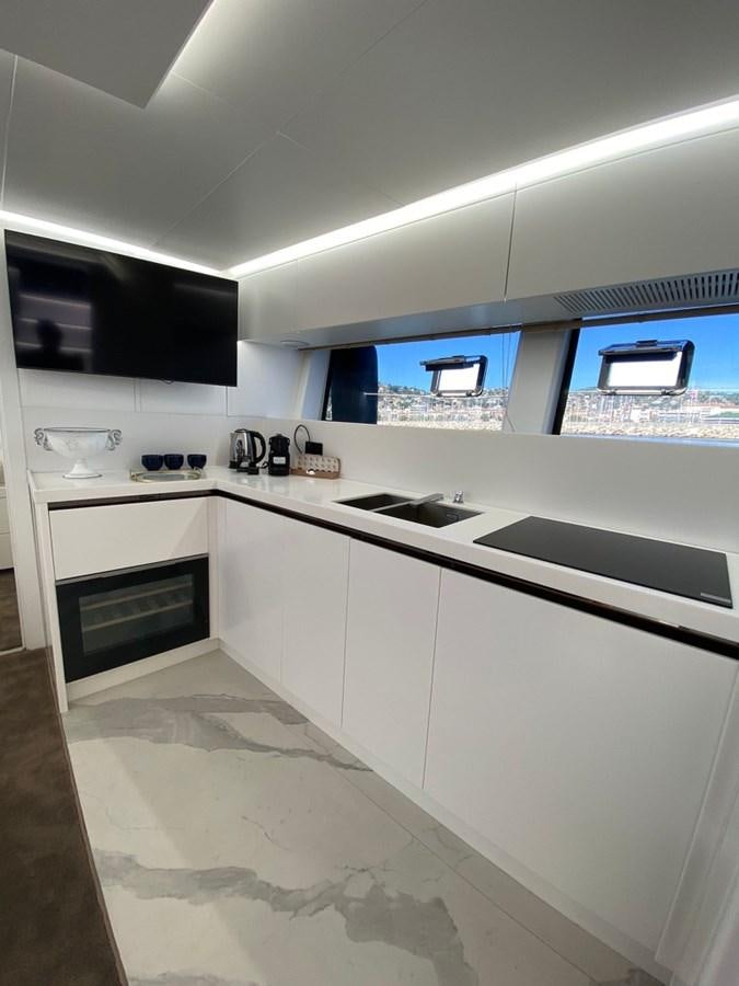a kitchen with white cabinets aboard SUERT 70 Yacht for Sale