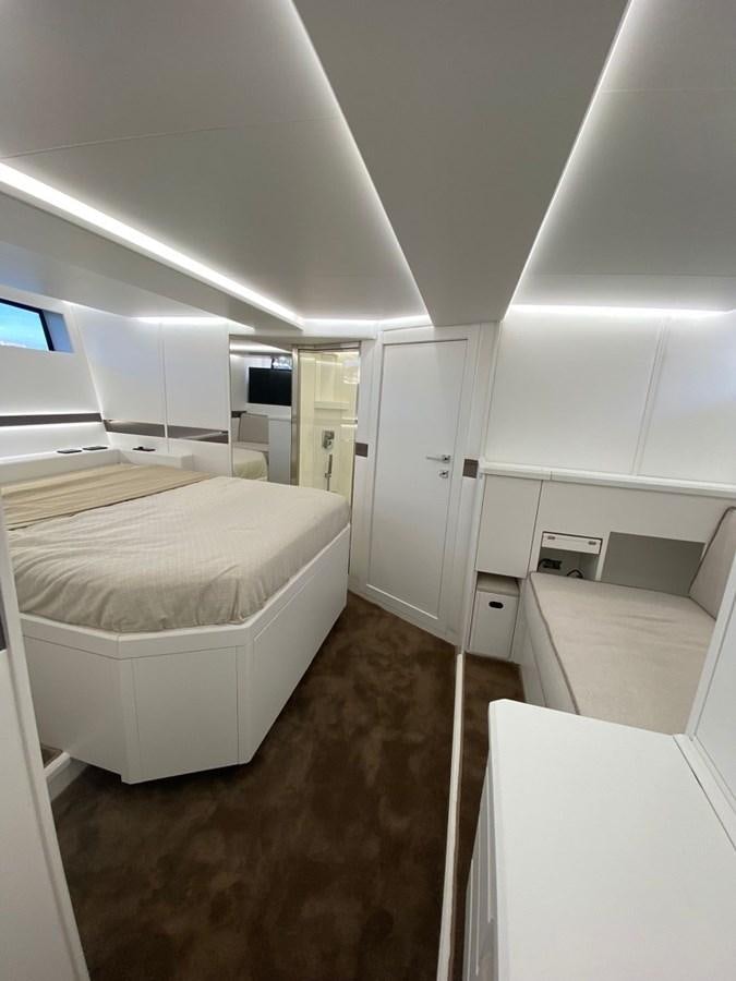 a room with white beds aboard SUERT 70 Yacht for Sale