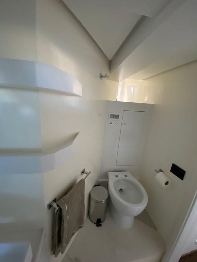 a bathroom with a toilet and a trash can aboard SUERT 70 Yacht for Sale