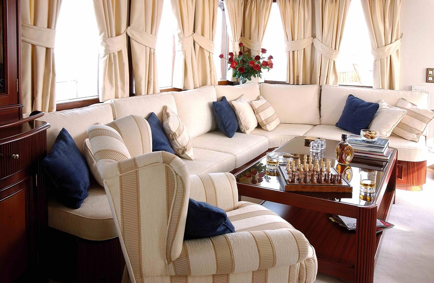 a living room with a couch and a coffee table aboard LIANA H Yacht for Sale
