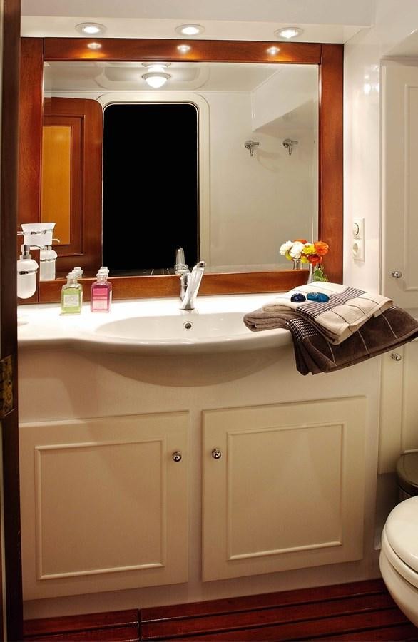 a bathroom with a large mirror aboard LIANA H Yacht for Sale
