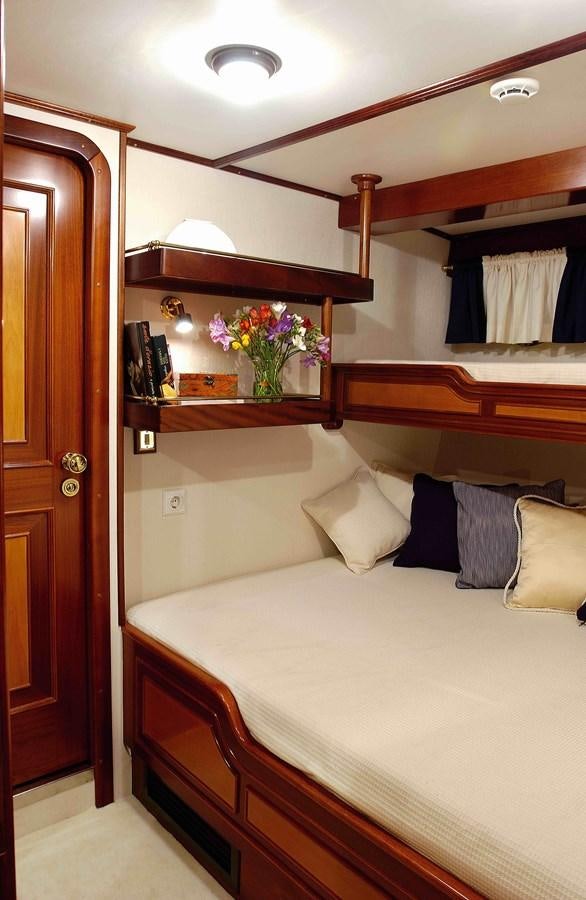 a bed with a mirror above it aboard LIANA H Yacht for Sale