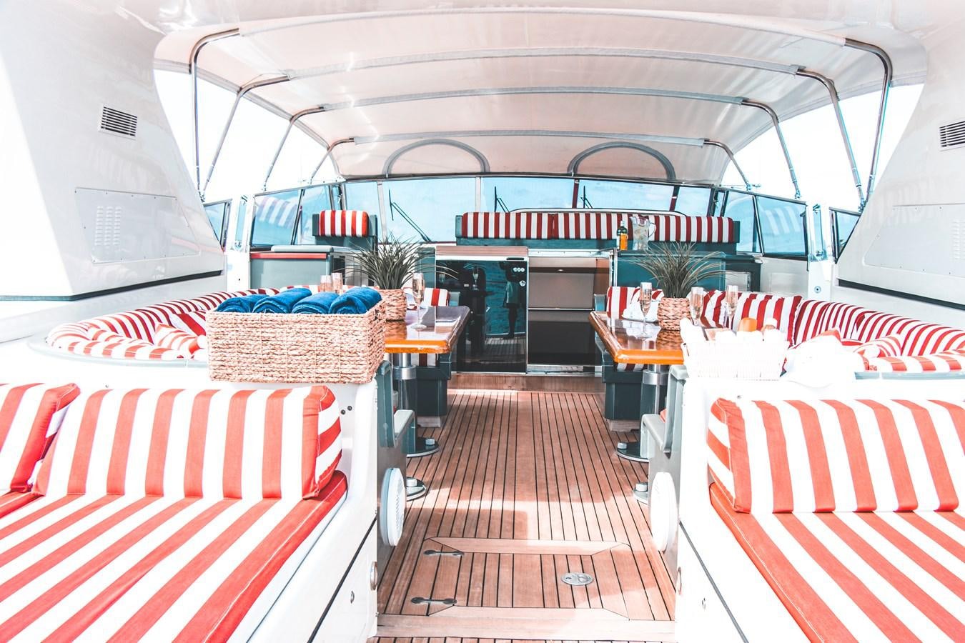 inside of a building with red and white striped seats and a red and blue striped mat on the aboard ROYAL ROCKSTAR Yacht for Sale