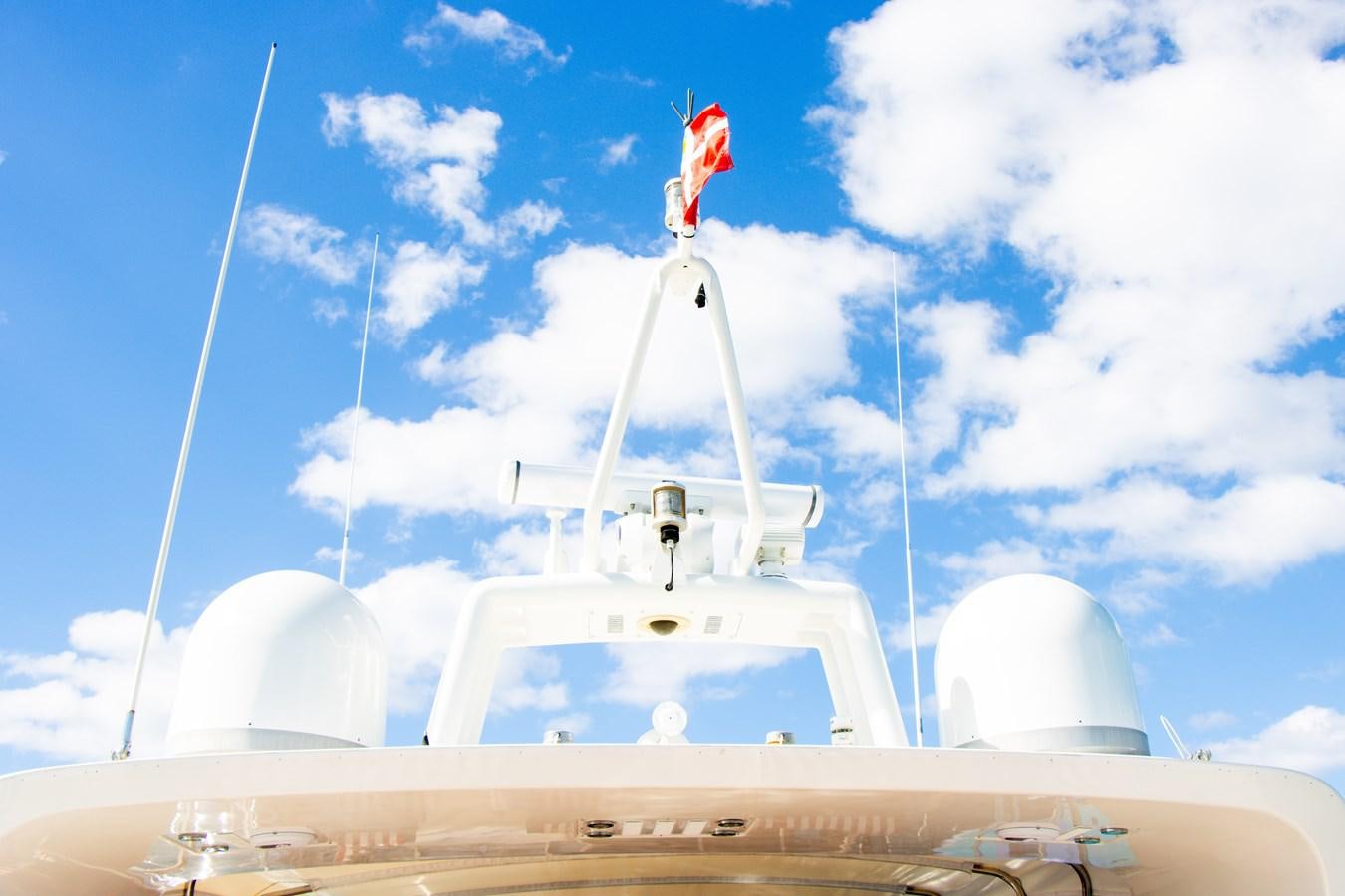 a boat with a flag on the front aboard ROYAL ROCKSTAR Yacht for Sale