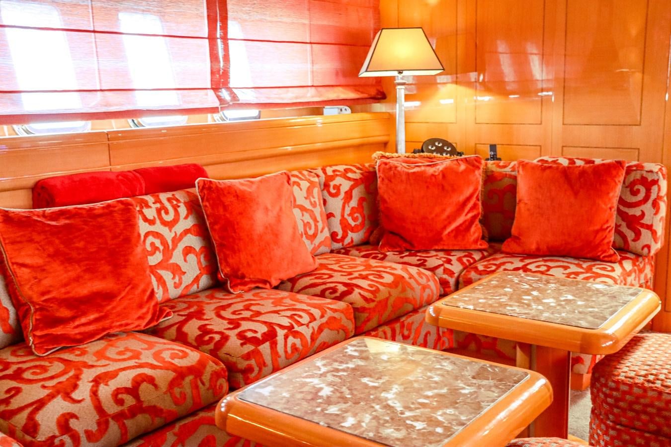 a couch with a table and a lamp on it aboard ROYAL ROCKSTAR Yacht for Sale