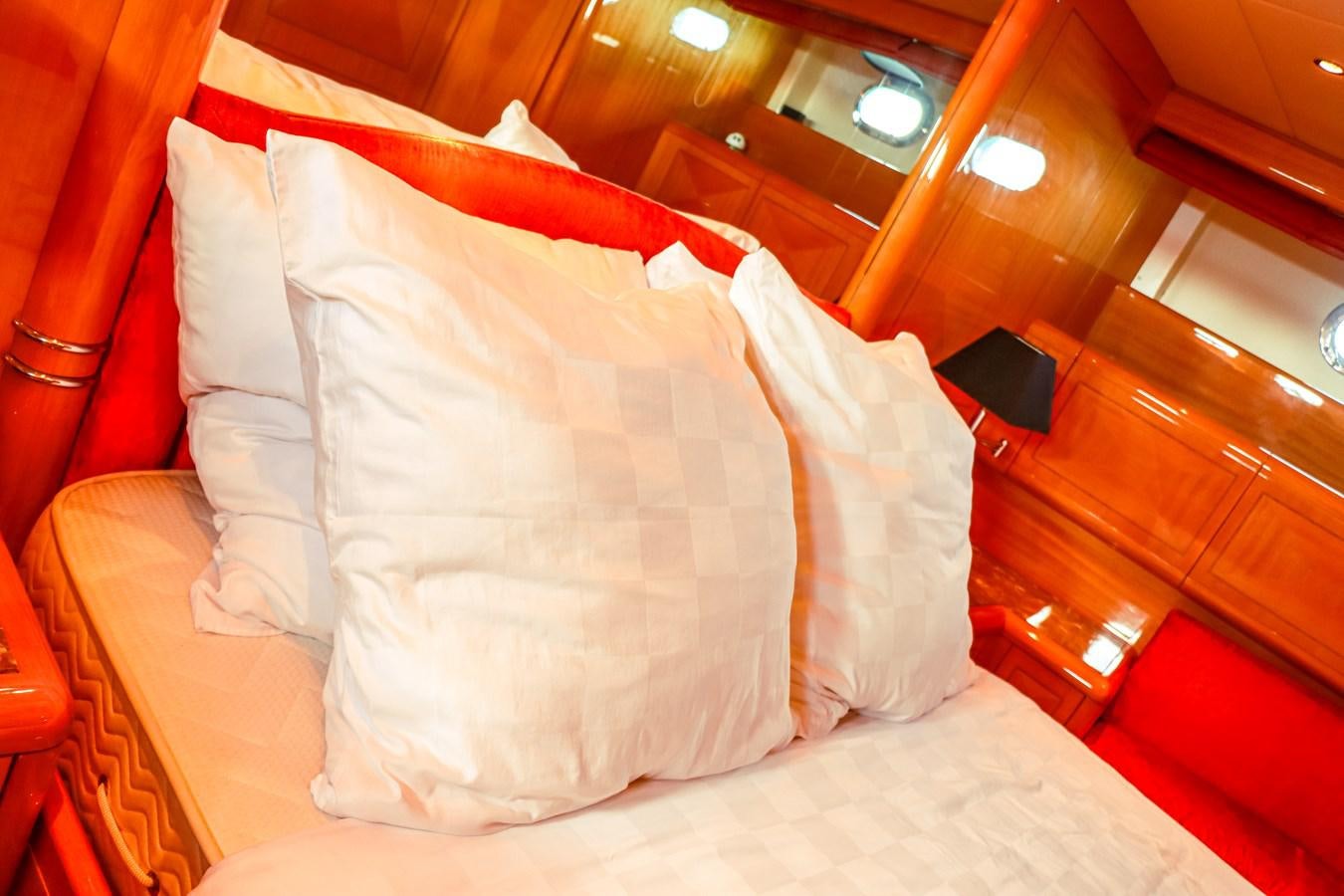 a bed with white pillows aboard ROYAL ROCKSTAR Yacht for Sale