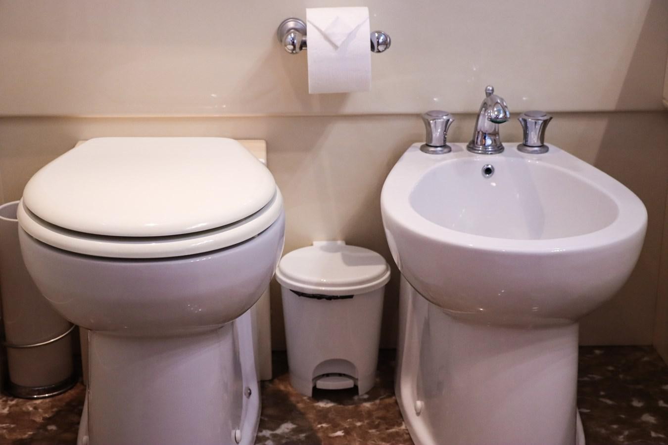 a toilet and sink in a bathroom aboard ROYAL ROCKSTAR Yacht for Sale