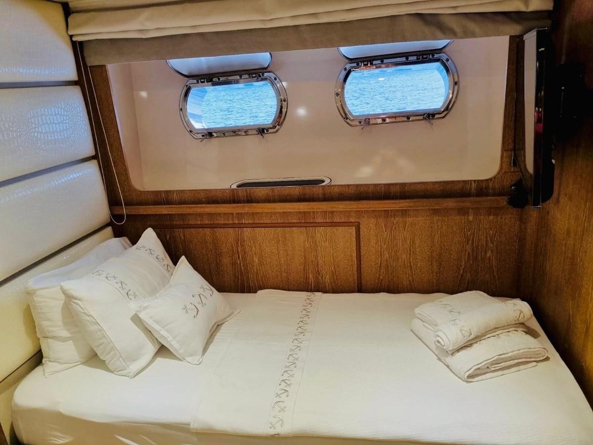 a bed with a tray on it aboard THIRTY LOVE Yacht for Sale