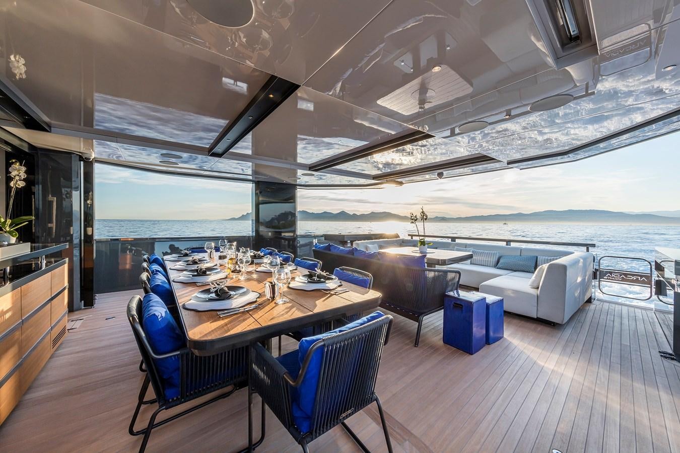 a room with a table chairs and a large window aboard SEA CORAL II Yacht for Sale