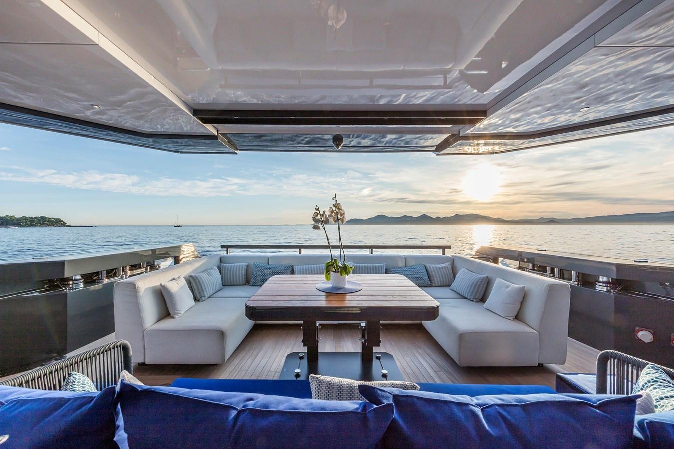 a room with a table and couches aboard SEA CORAL II Yacht for Sale