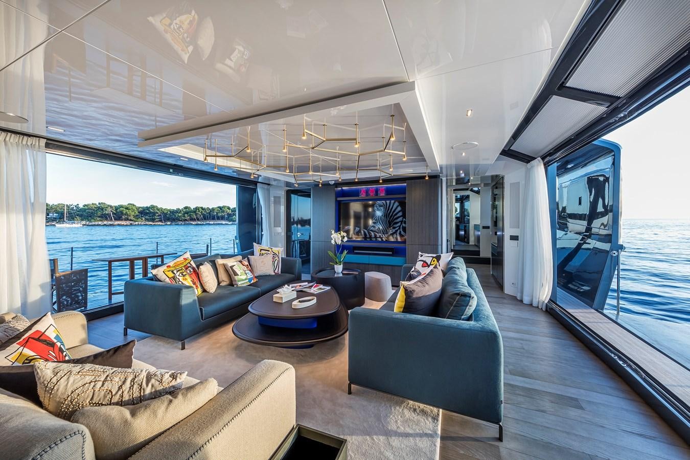 a living room with a large window aboard SEA CORAL II Yacht for Sale
